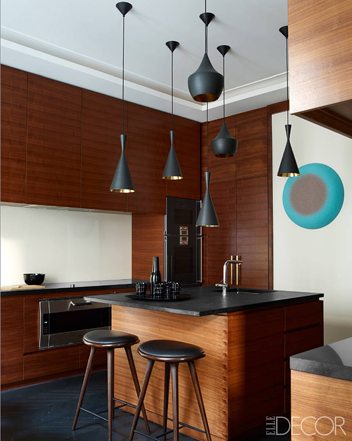 Parisian-Apt-by-Champeau-Wilde-kitchen-walnut-veneer-cabinetry-black-granite-countertops-Tom-Dixon-pendants.jpg