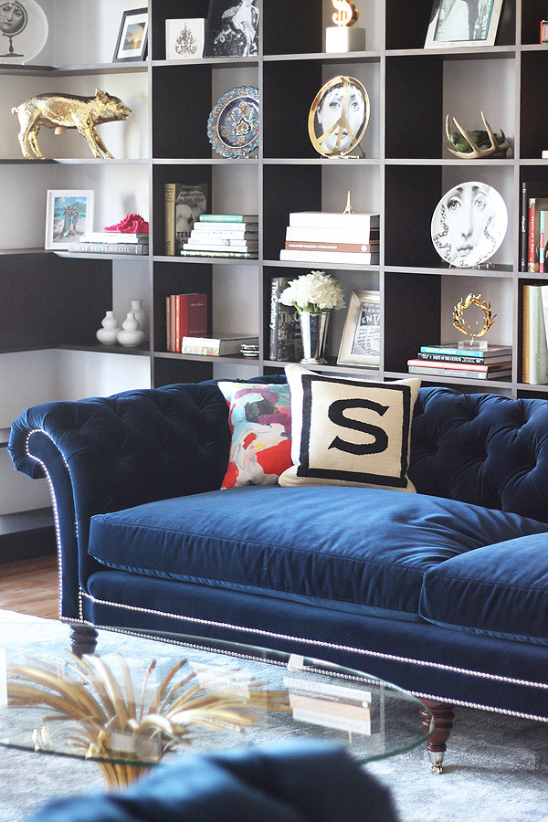 Soho NYC loft Tamra Sanford blue velvet tufted sofa bookshelves