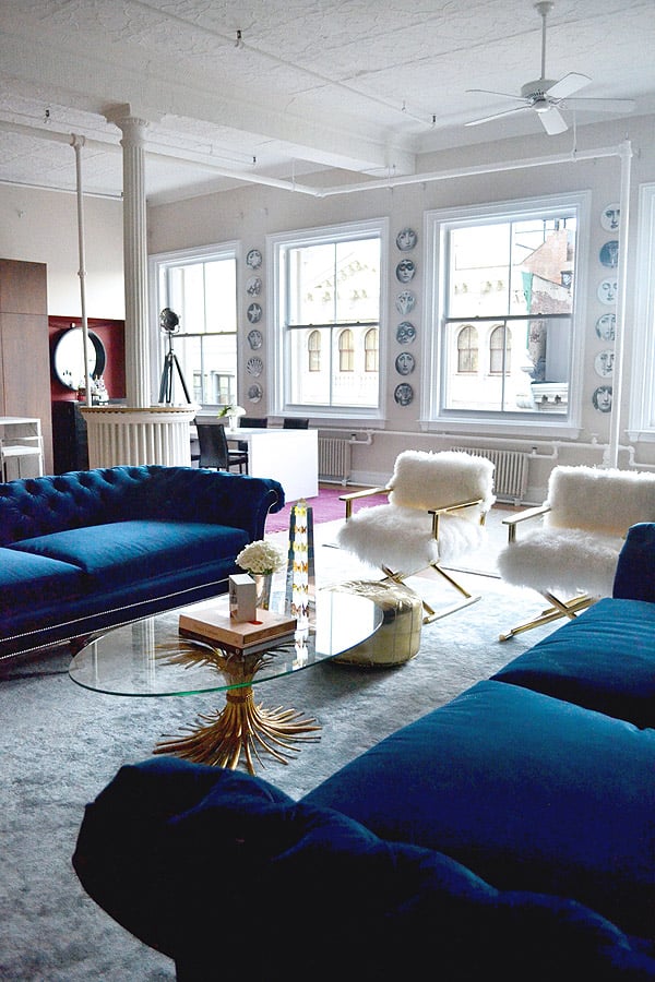 Soho NYC loft Tamra Sanford living room fuzzy chairs blue velvet sofas windows