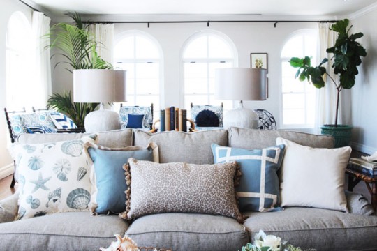Ones Nest blue ivory leopard accent pillows white ceramic lamps brass bookends brass mirror tray