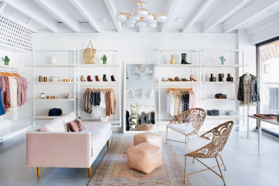 Adelante Boutique by Claire Zinnecker pink couch white gold peach natural peacock bucket chairs