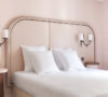 Hotel Bienvenue room blush walls deco 70s yellow stool
