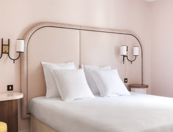 Hotel Bienvenue room blush walls deco 70s yellow stool